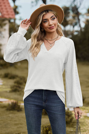 White waffle knit raglan sweater with laser cut sleeves and V-neck