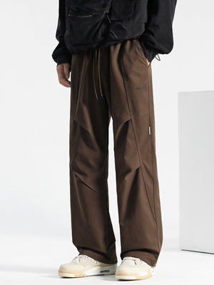 Brown drawstring sweatpants with panel detailing and subtle logo.
