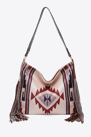 Southwestern fringe hobo bag in beige canvas with geometric pattern and leather strap.