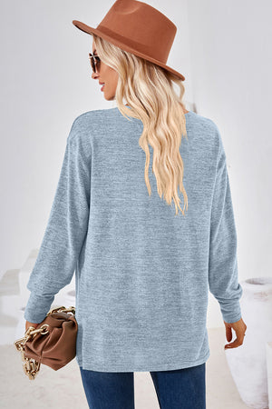 Light blue relaxed V-neck tunic top with long sleeves and heathered texture.