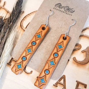 Embroidered leather dangle earrings with turquoise inlay and copper accents.