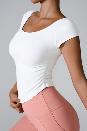 White performance tee with gathered side detail and scoop neck.