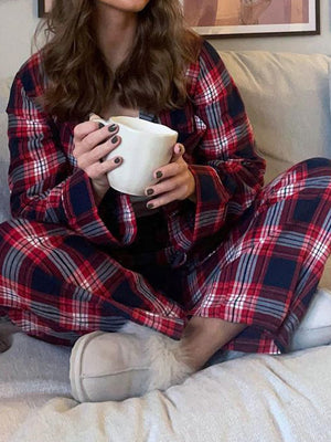 Crimson plaid pajama set with long sleeves and pants, made of polyester.