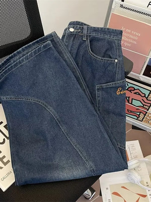 Classic vintage wash wide-leg jeans in dark blue cotton with angular pockets and subtle embroidery.