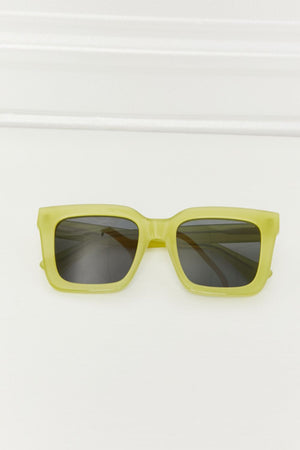Citron box frame sunglasses with acetate material and dark lenses.