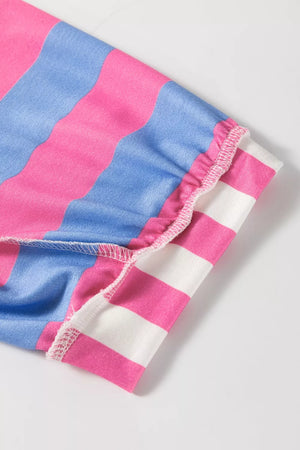 Overshirt with pink, blue, and white wavy stripes and ruffled sleeve hem detail.