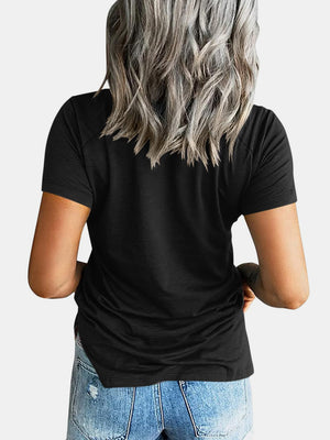 Black raglan t-shirt with short sleeves and a relaxed fit, paired with denim shorts.