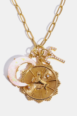Gold celestial zodiac pendant necklace with moon and Aries charm.