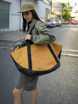 Yellow and black large capacity travel bag with black base and straps.