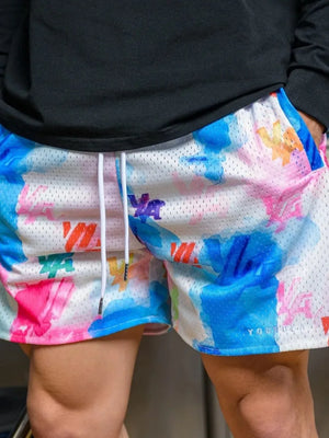 Mesh athletic shorts with abstract floral print in blue, pink, and orange.