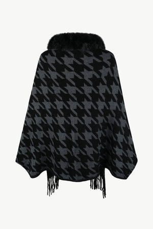 Houndstooth poncho with faux fur collar and fringe detail in black and grey.