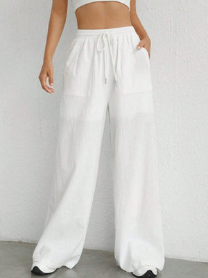 White linen wide-leg drawstring trousers with pockets