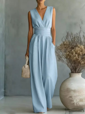 Sky blue sleeveless wide-leg jumpsuit with V-neck, cinched waist, and pockets.