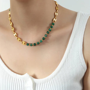 Gilded bead and chain necklace with green beads and gold accents.