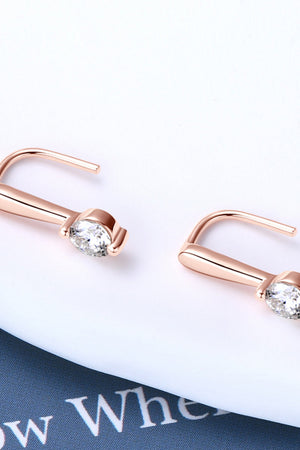 Rose gold moissanite hook earrings with clear round-cut stones.