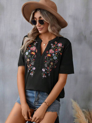 Black V-neck tunic with colorful floral embroidery and crochet trim detail