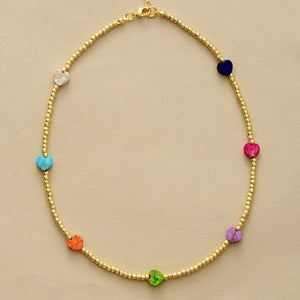 Gold beaded necklace with multicolor heart charms