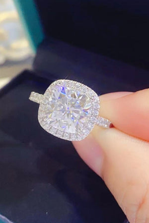 White cushion-cut halo engagement ring with diamond band