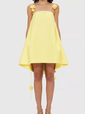 Yellow A-line mini dress with floral applique straps and hem detail.