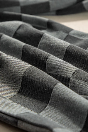 Checkerboard denim wide leg trousers in dark gray with a textured weave.