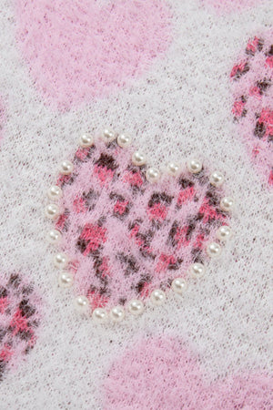 Fuzzy knit sweater in blush pink with a pearl-embellished heart jacquard pattern.