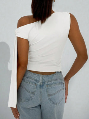 White asymmetrical tie detail cropped blouse with one sleeve and one sleeveless side.