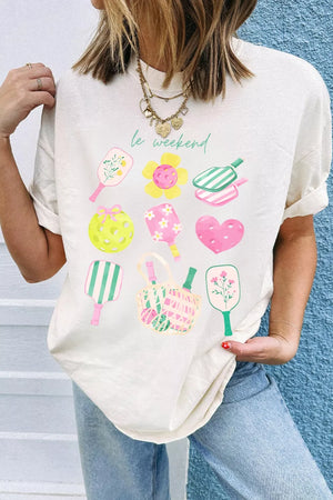 Cream polyester t-shirt with playful pickleball graphic and text.
