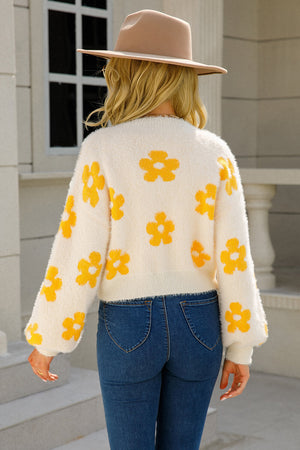 Cream fuzzy cropped cardigan with yellow floral print and balloon sleeves.