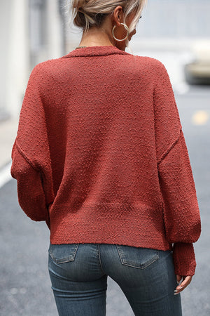 Textured bouclé button-down cardigan in rust with a relaxed fit and dropped shoulders.