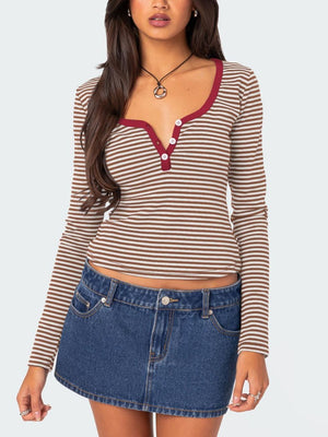 Striped long sleeve henley shirt with contrast collar and buttons.
