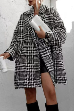 Oversized houndstooth cocoon coat in black and white with a double-breasted closure.