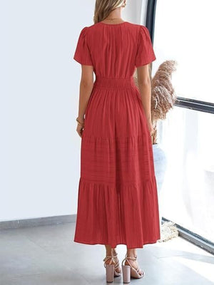 Rust tiered maxi dress with smocked waist and short puff sleeves.