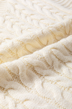 Ivory cable knit mock neck vest with chunky texture.