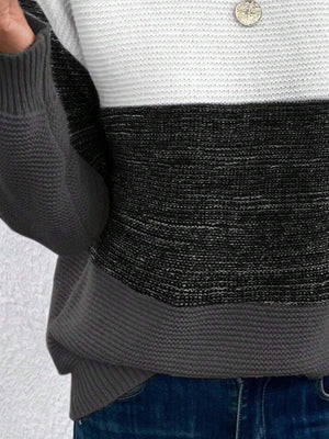 Colorblock ribbed knit sweater with white, black, and gray stripes.