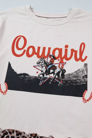 Cowgirl graphic tee in cream cotton blend with ruffled leopard hem.