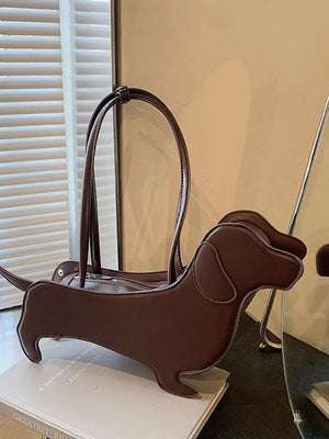 Coffee color PU leather dachshund shoulder bag with top handles and zipper closure.