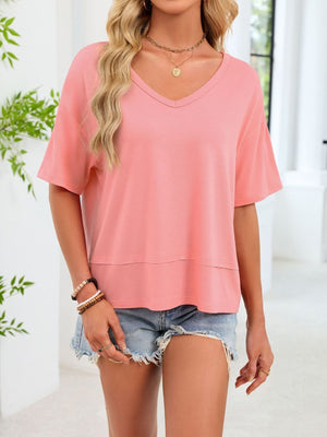 Pink relaxed fit v-neck t-shirt with short sleeves and a layered hem detail.