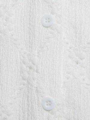White lace-trimmed button-up maternity shirt with textured fabric and ruffle sleeves.
