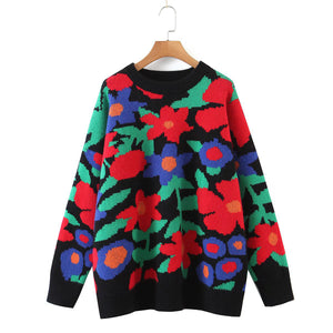 Black crewneck knit sweater with a vibrant floral intarsia pattern.