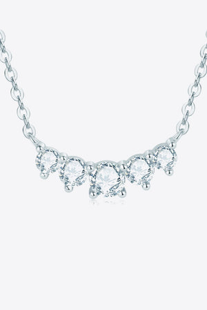 Celestial Arc Necklace in silver with five clear round gemstones on a delicate chain.