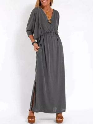 Gray V-neck maxi dress with dolman sleeves, elastic waist, and side slits.