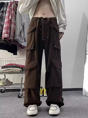 Brown cargo pants with multiple large pockets and a drawstring waist.