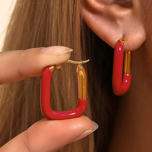 Red and gold two-tone enamel rectangle hoop earrings with a bold, chic design.