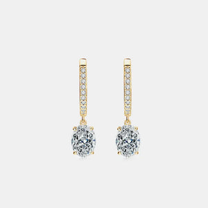Gold pavé hoop and oval moissanite drop earrings with clear stones.