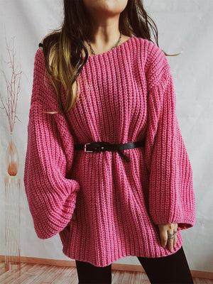 Hot pink oversized ribbed knit sweater with belted waist and balloon sleeves.
