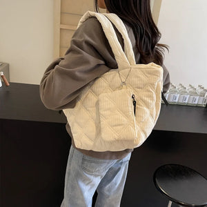 Quilted ivory tote bag with zippered pouch and chain detail