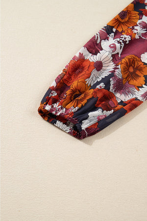 Floral wrap mini dress with puff sleeves and elastic cuff in navy with red and orange flowers