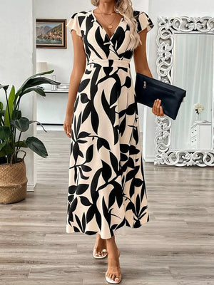 Floral print midi dress with cap sleeves and a V-neck in black and apricot abstract pattern.