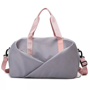 Light gray nylon travel bag with pink straps and adjustable shoulder strap.
