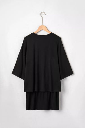 Black two-piece set with a relaxed fit tee and tiered skirt.
